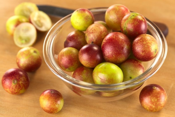Camu camu berry fruits (lat. Myrciaria dubia) which are grown in the Amazon region and have a very high Vitamin C content (Selective Focus, Focus on the berries in the middle of the bowl) Forrás: 123rf.com