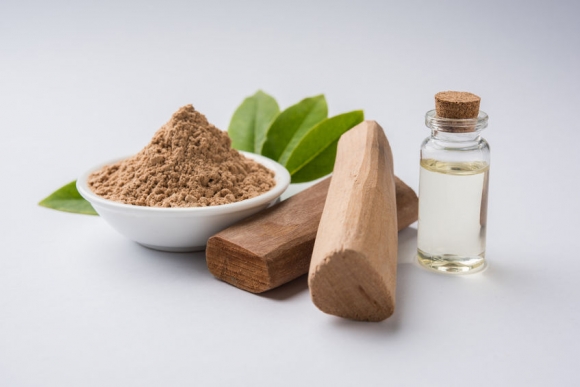 Chandan or sandalwood powder with traditional mortar, sandalwood sticks, perfume or oil and green leaves. selective focus (Forrás: 123rf.com)